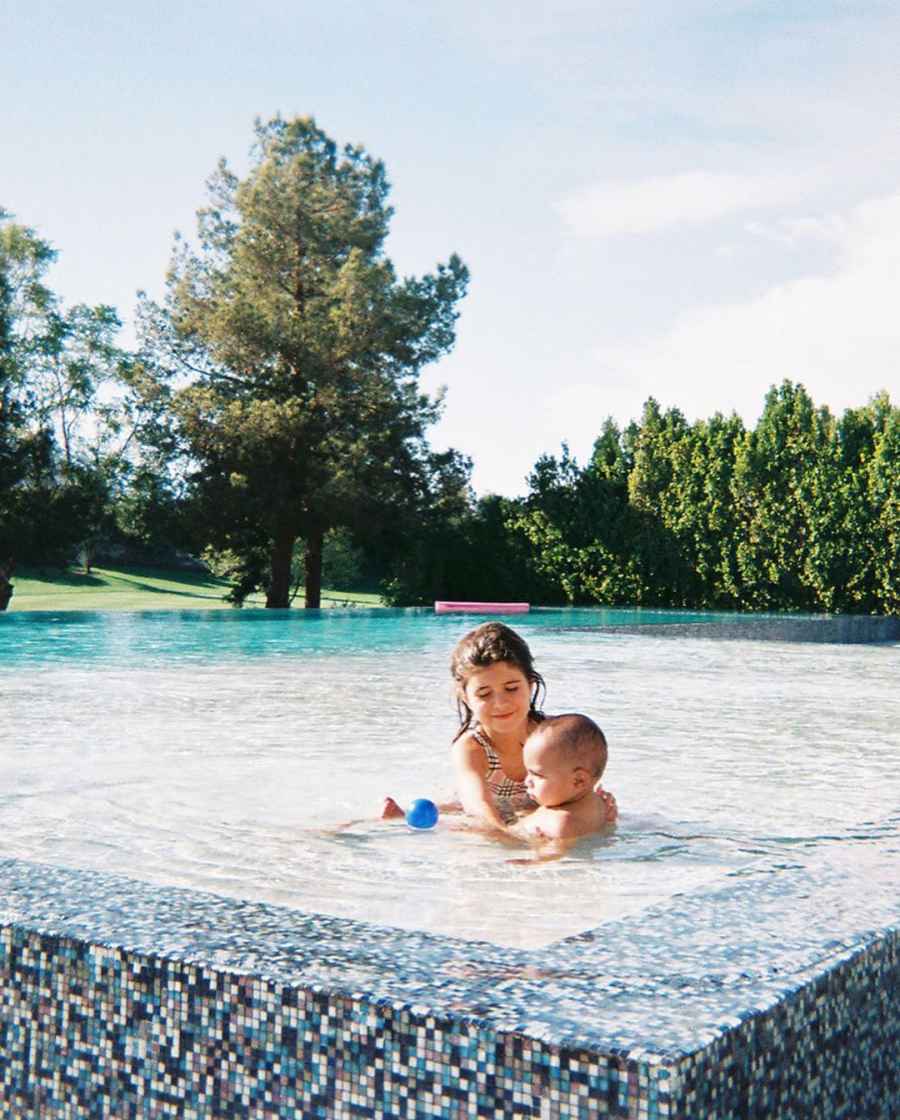 Penelope Disick playing with Psalm West in a Palm Springs pool