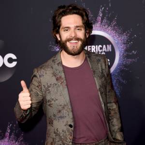 Thomas Rhett baby spits up on him