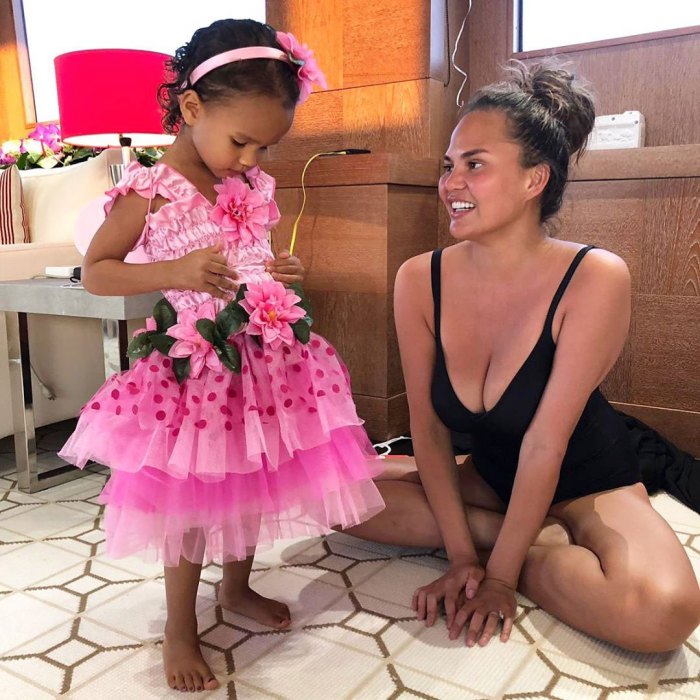 Chrissy Teigen Catches Daughter Luna Snacking in the Pantry Batching Suit Pink Dress