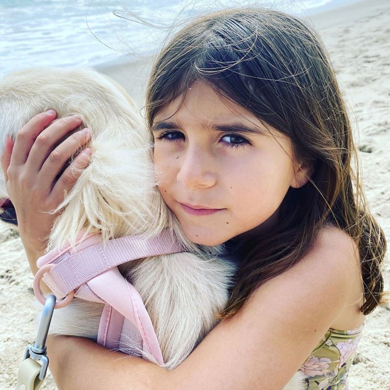 Penelope Disick Cuddling a Dog on the Beach