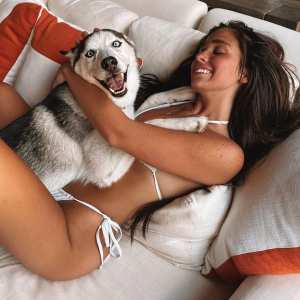 Ariana Biermann Cuddles with a Dog in a Bikini Mom Kim Zolciak Designed