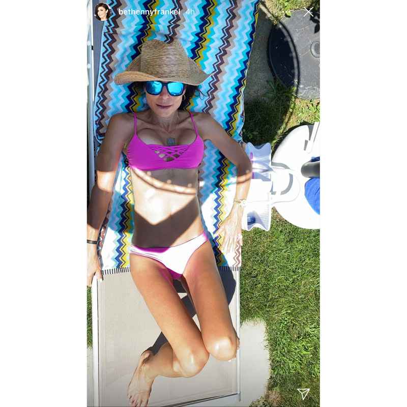 Bethenny Frankel in a hot pink bikini sunglasses and beach hat