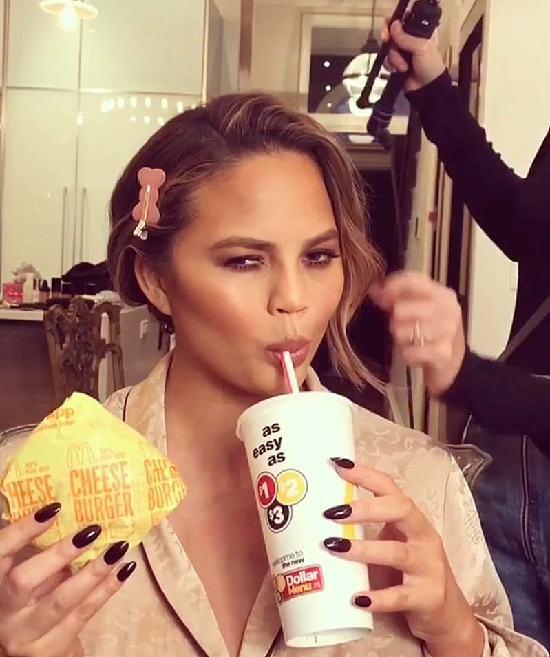 Chrissy Teigen eating while getting ready