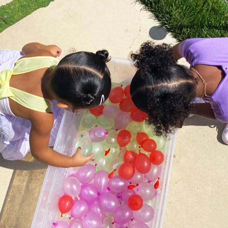 Stormi Webster and True Thompson Playing with Water Balloons