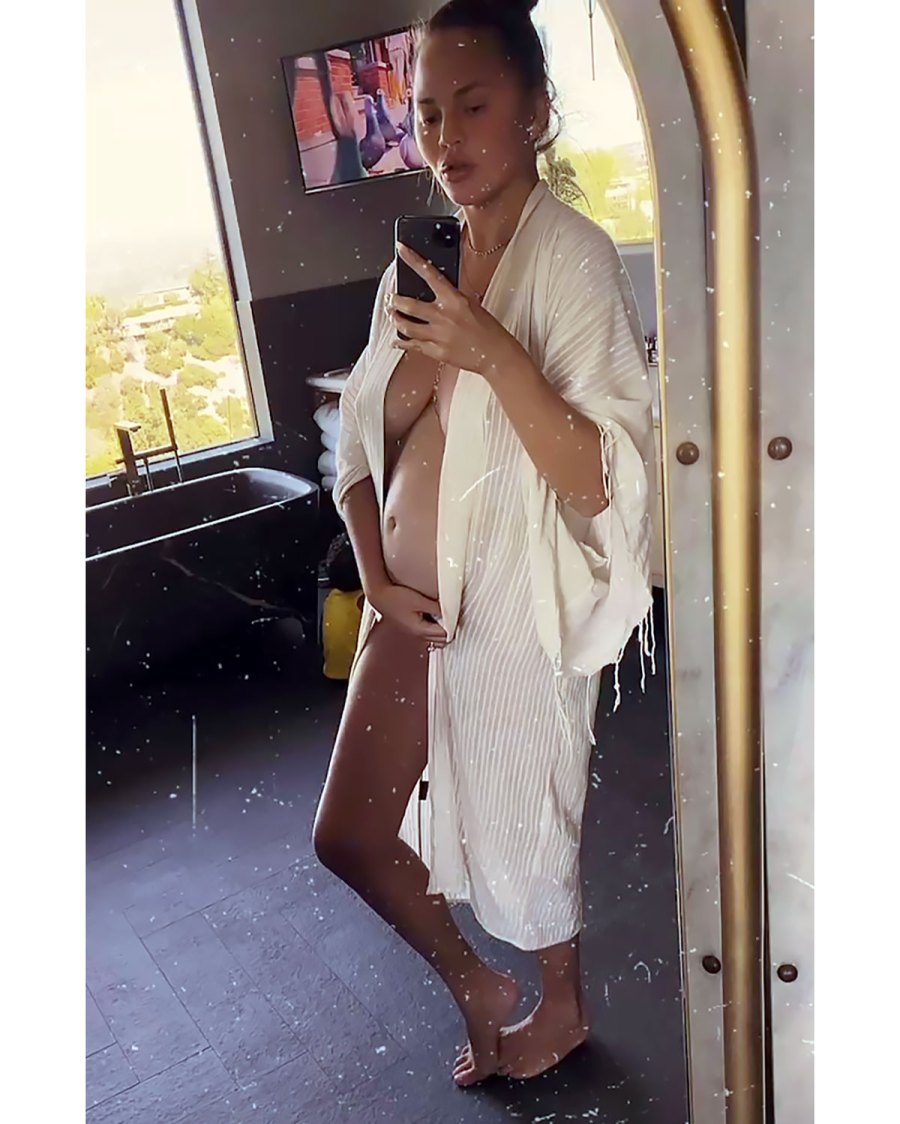 Chrissy Teigen Shows Off Her Growing Baby Bump in a Chic Robe