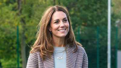 Duchess Kate Visiting The University Of Derbvy In A Plaid Coat And Carrying An Umbrella