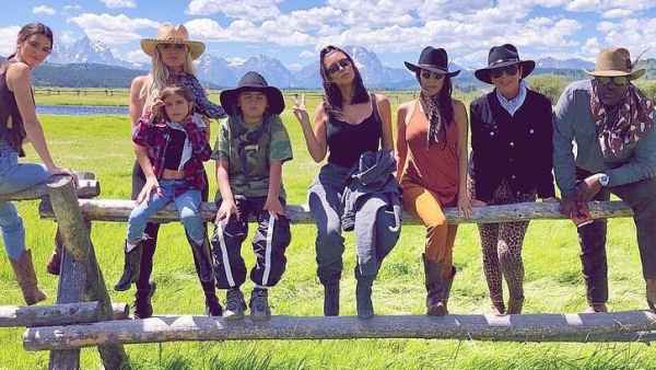 Kim Kardashian Enjoys Family Time Ahead of Her 40th Birthday Family Sitting Fence