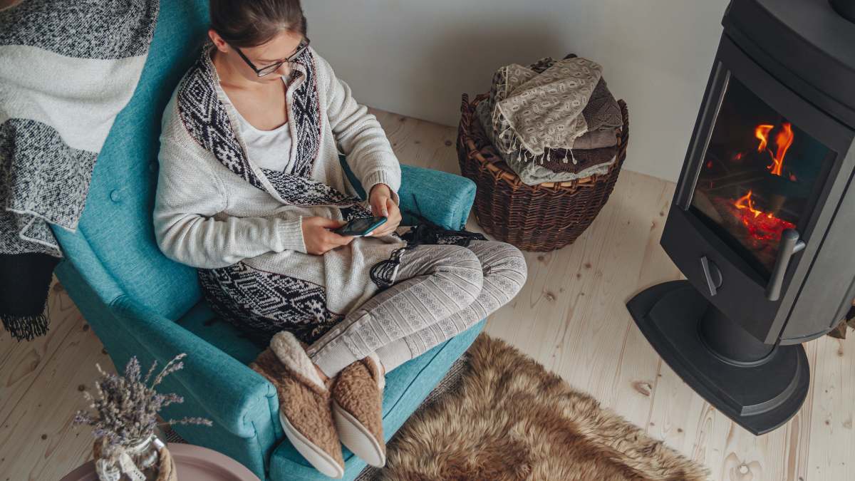 woman-sitting-at-home-in-slippers-stock-photo