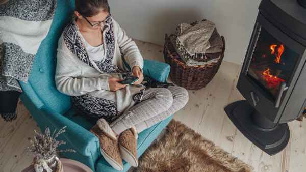 woman-sitting-at-home-in-slippers-stock-photo