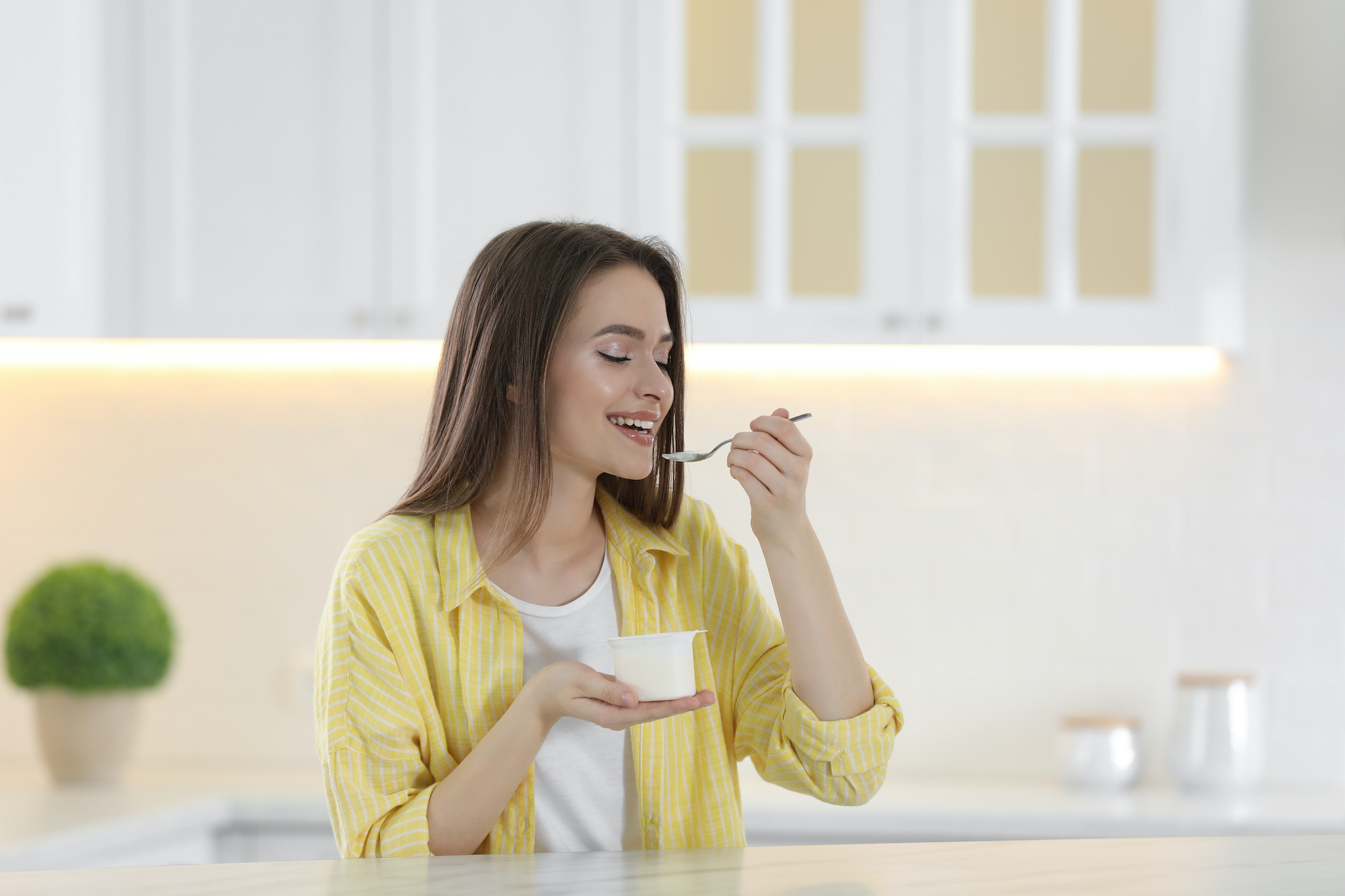 Woman-Eating-Yogurt-Stock-Photo