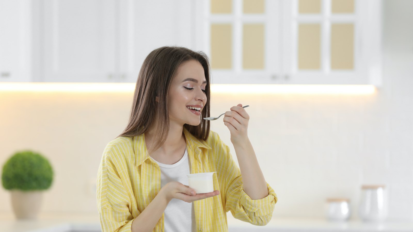 Woman-Eating-Yogurt-Stock-Photo