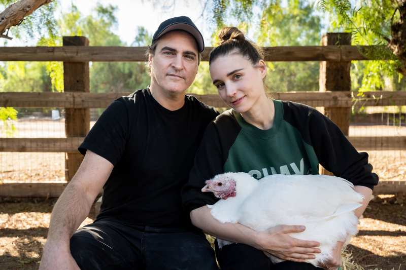 Joaquin Phoenix and Rooney Mara hold a chicken at California's Farm Sanctuary.