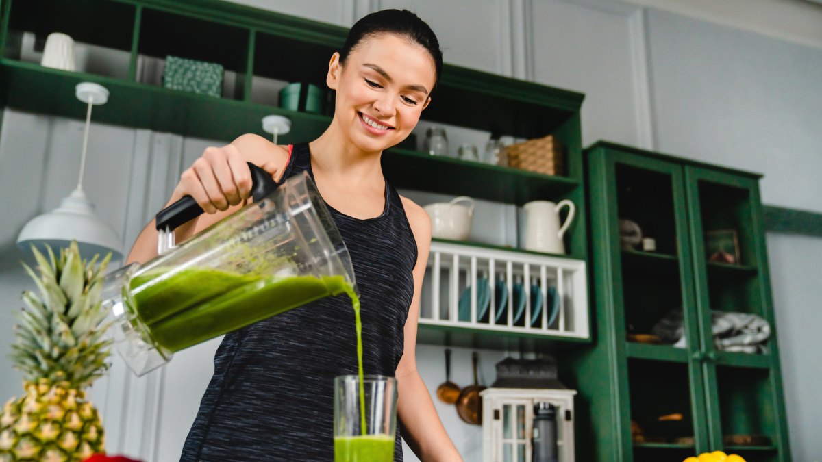 Woman-Using-Blender-Stock-Photo
