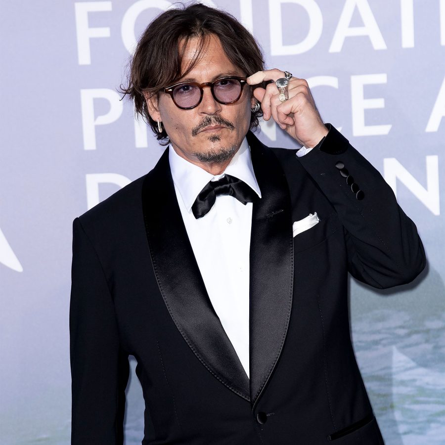 Johnny Depp and Amber Heard's Legal Drama black suit glasses