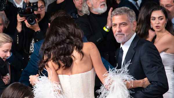 George Clooney Helps Wife Amal Avoid Major Wardrobe Malfunction at Tender Bar Premiere