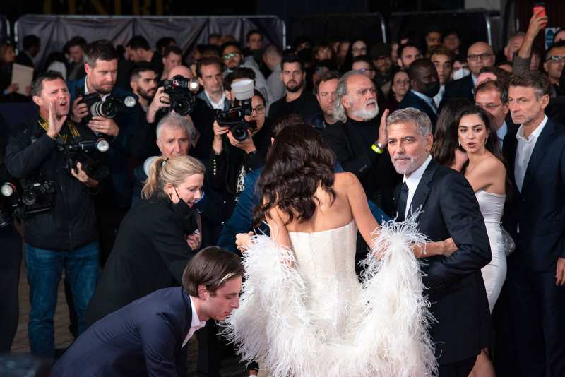 George Clooney Helps Wife Amal Avoid Major Wardrobe Malfunction at Tender Bar Premiere