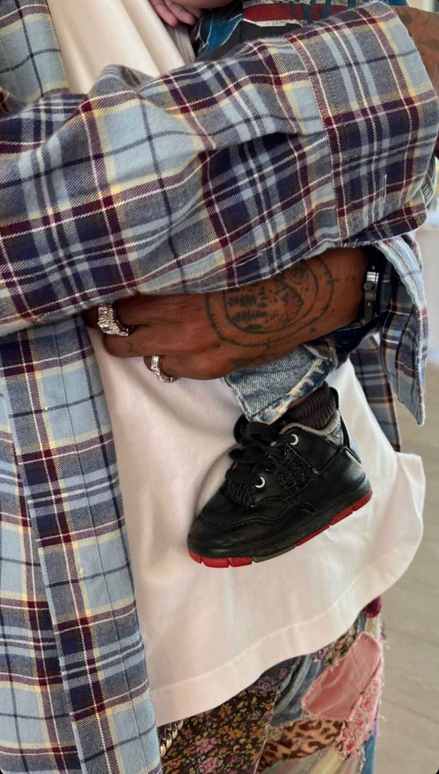 Travis Scott holds his and Kylie Jenner's son