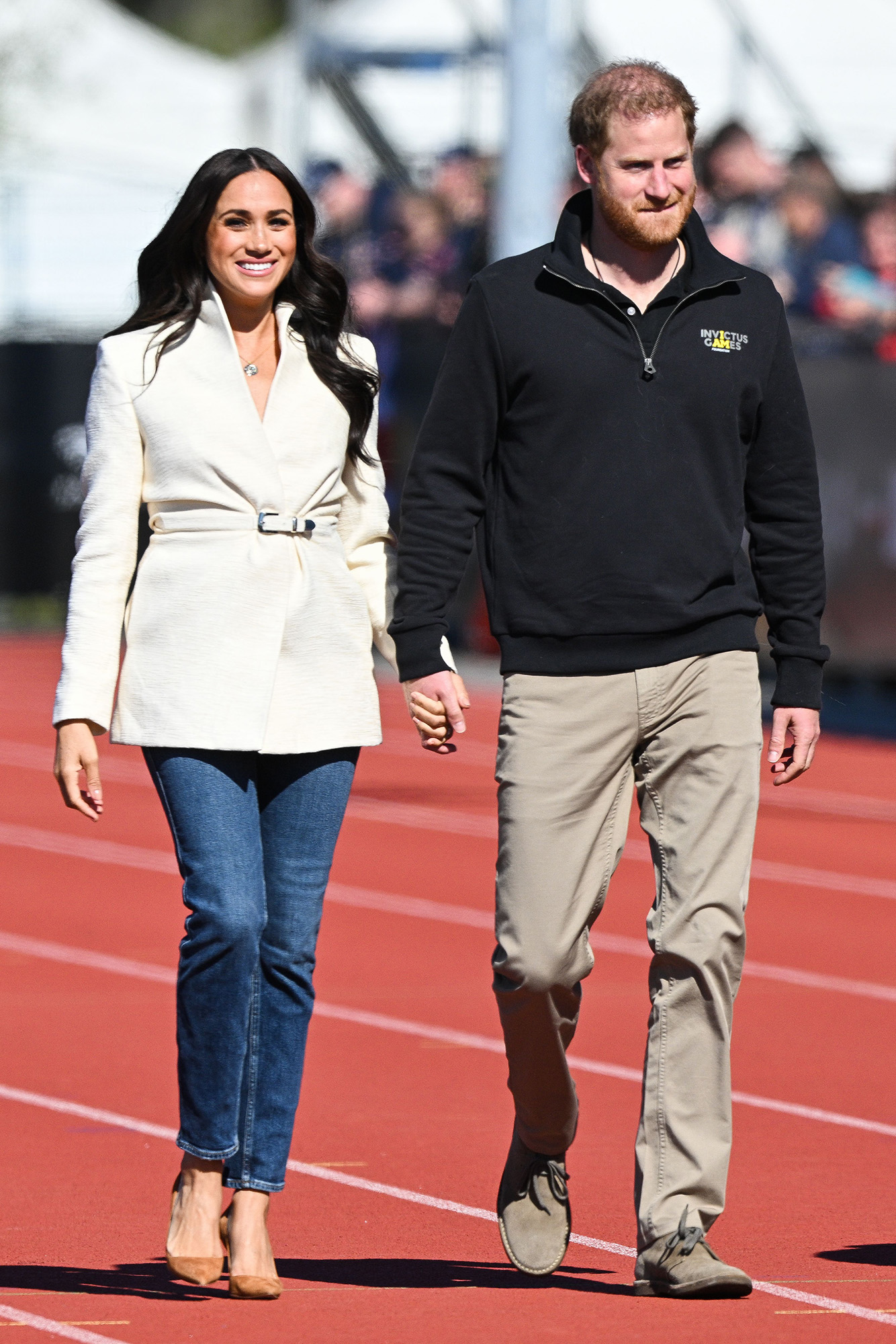 Prince Harry and Meghan Markle hold hands at 2022 Invictus Game