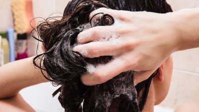 Woman-Shampooing-Hair-Stock-Photo