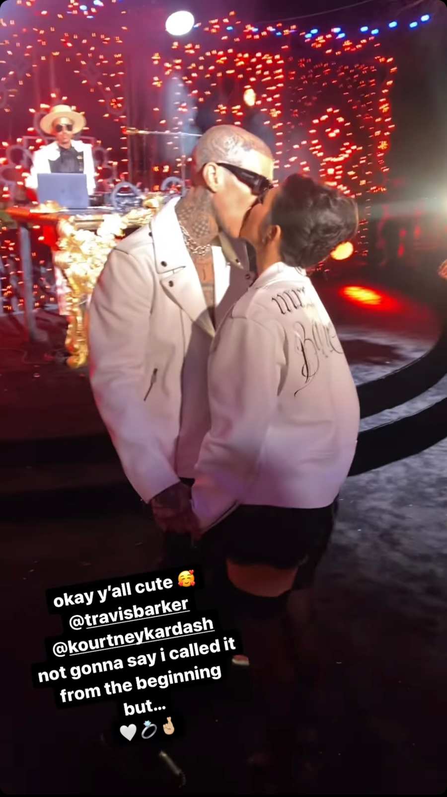 Kourtney and Travis in white jackets at their wedding