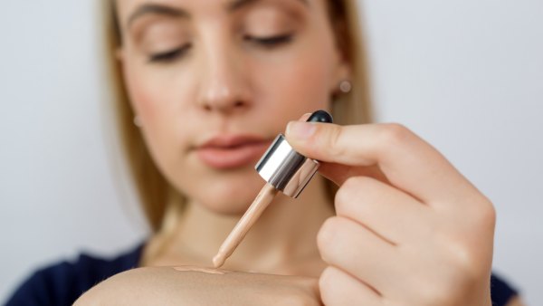 Woman-Putting-On-Liquid-Foundation-Stock-Photo