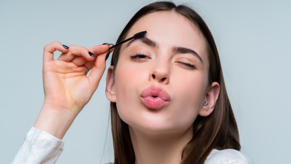 Woman-Fixing-Eyebrows-Stock-Photo