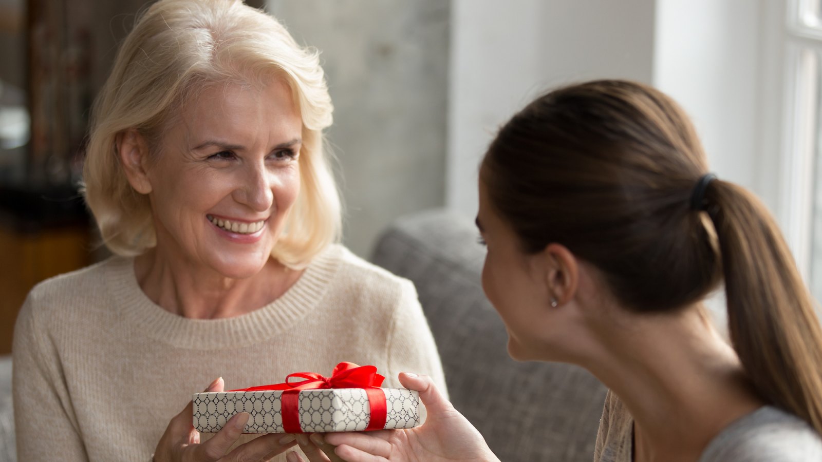 Older-Woman-Getting-Gift-Stock-Photo