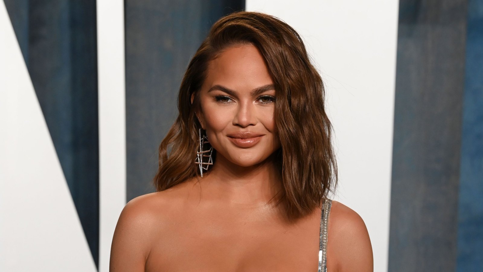 Pregnant Chrissy Teigen Wows in a Skintight Floral Dress