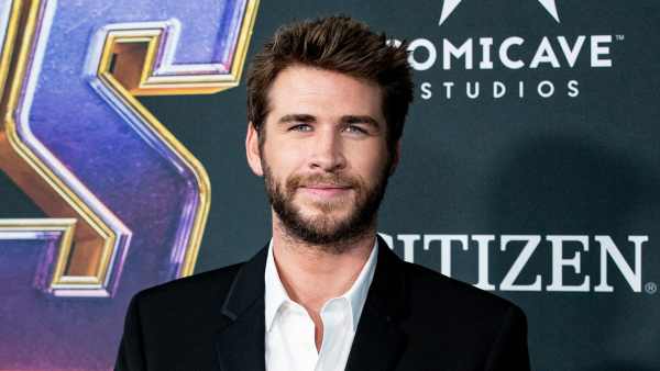 Shirtless Liam Hemsworth Cuddles — and Kisses — His Beloved Dog Dora in Adorable Photo