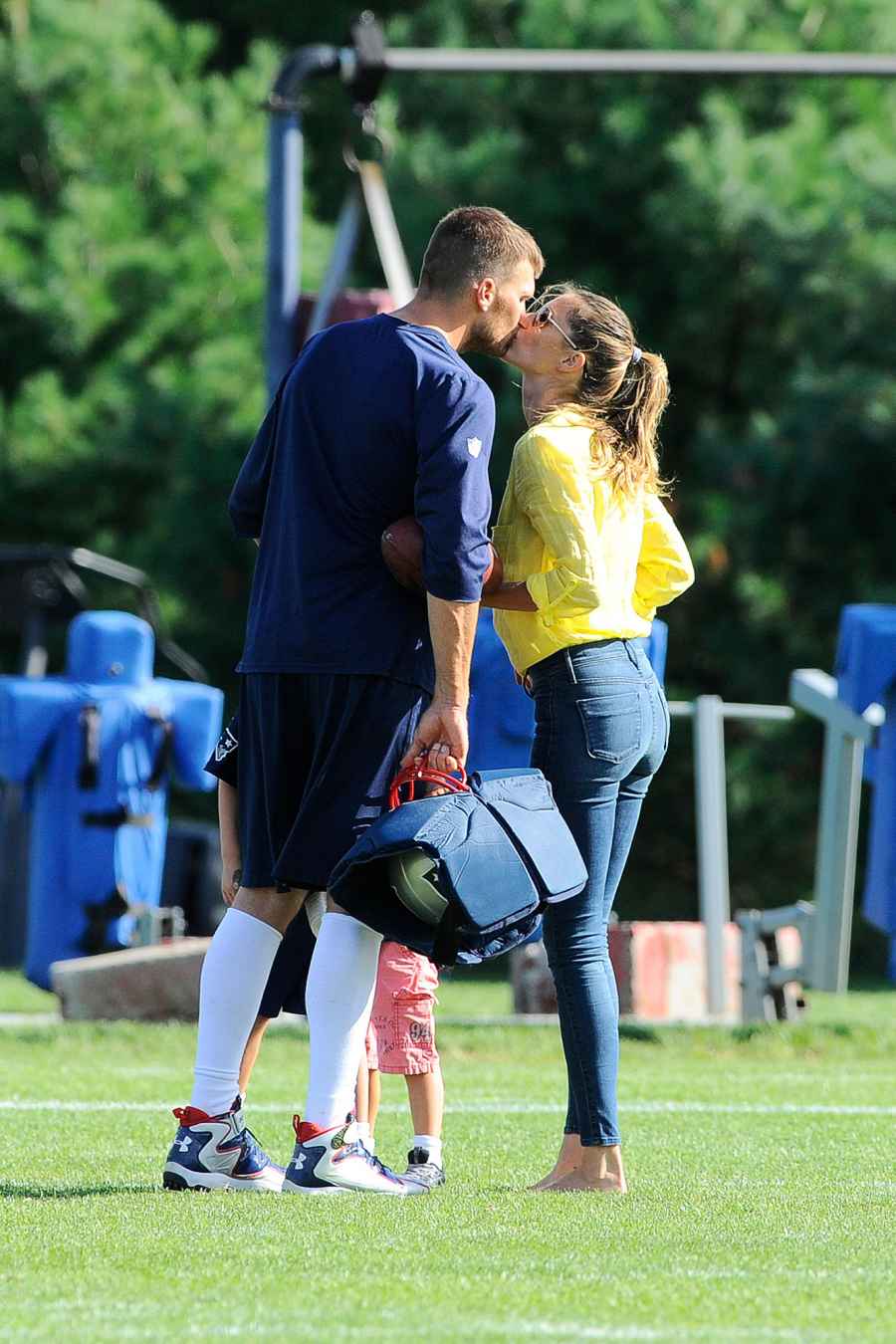 Tom Brady and Gisele Bundchen's Relationship Timeline kissing at football practice