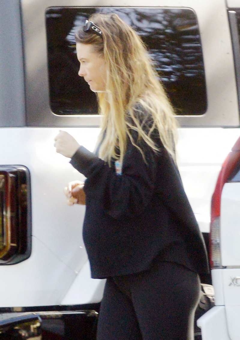 Behati Prinsloo shows off her baby bump 005 EXCLUSIVE: Behati Prinsloo shows off her growing baby bump in a warm all black winter ensemble while running errands on a solo outing without Adam Levine
