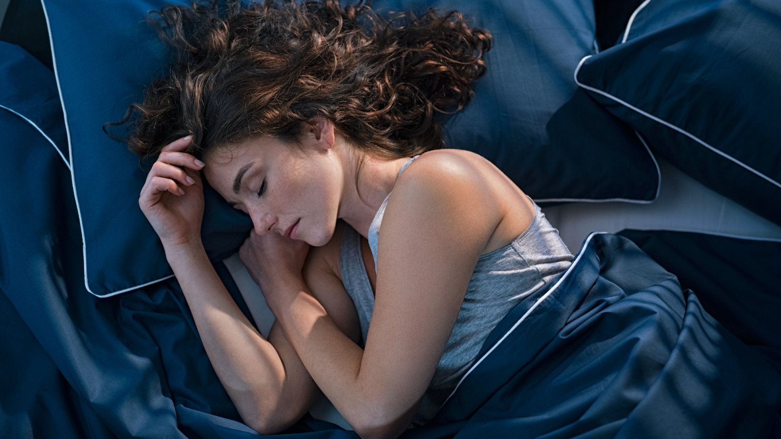 Woman-Sleeping-In-Bed-Stock-Photo