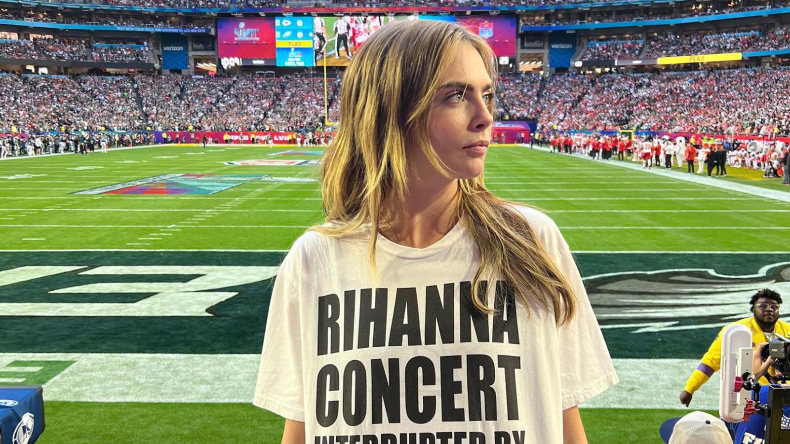 Cara D Wears Team Rihanna Shirt at Super Bowl football field