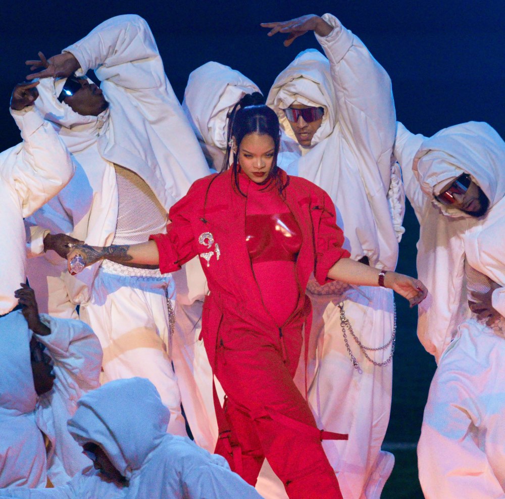 Cara D Wears Team Rihanna Shirt at Super Bowl red suit