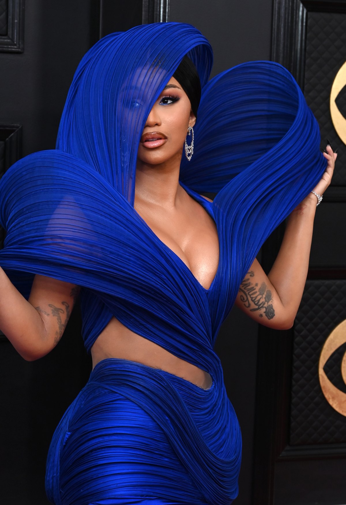 Cardi B Hits the 2023 GRAMMYs Red Carpet in Dramatic Hooded Cutout Gown