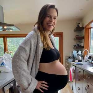 Hilary Swank Shows Off Baby Bump After Announcing She’s Expecting Twins With Husband Philip Schneider black sports bra