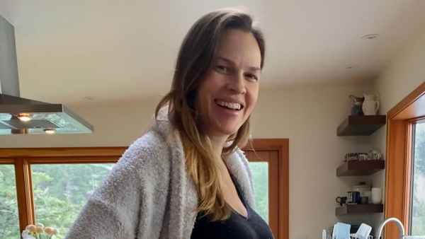 Hilary Swank Shows Off Baby Bump After Announcing She’s Expecting Twins With Husband Philip Schneider black sports bra