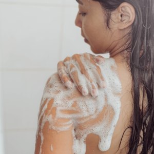 Woman-Using-Body-Wash-Stock-Photo
