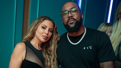 Happy in love!  Larsa Pippen and BF Marcus Jordan cuddle at the F1 Bash