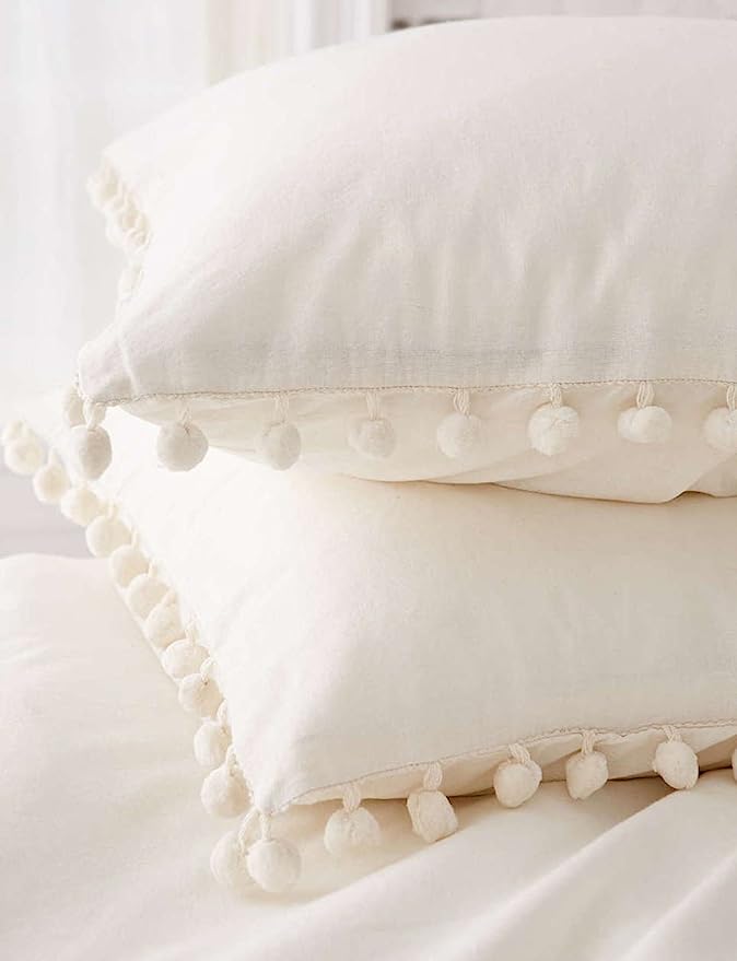 white pom-pom pillow covers