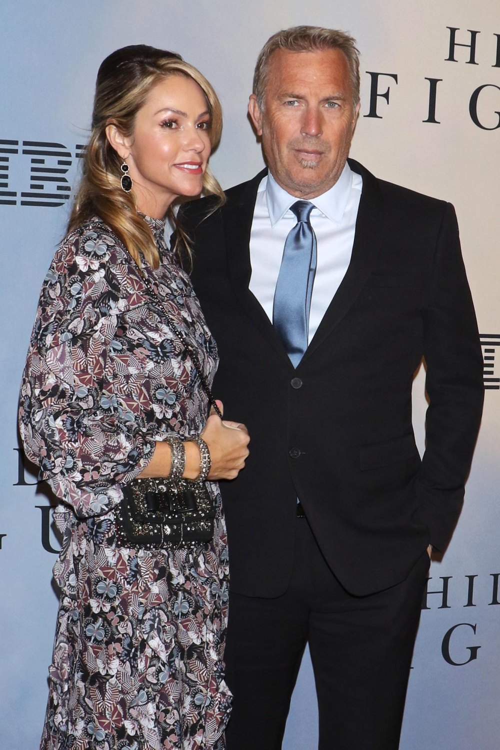 Kevin Costner's estranged wife wears Prada purse after begging