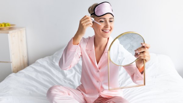 Woman-Applying-Face-Serum-Before-Bed-Stock-Photo
