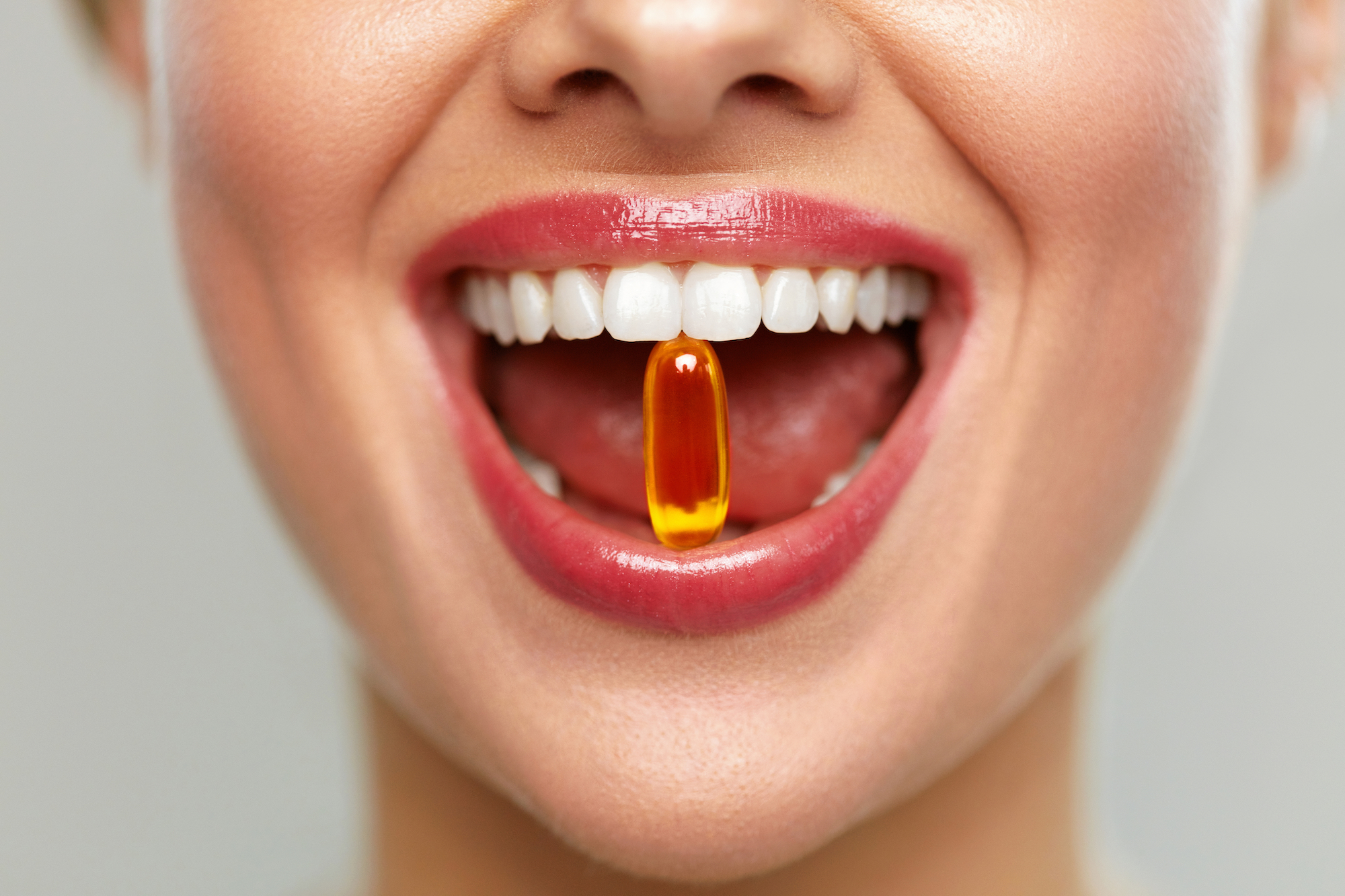 Woman-Taking-Vitamin-Closeup-Shot-Stock-Photo