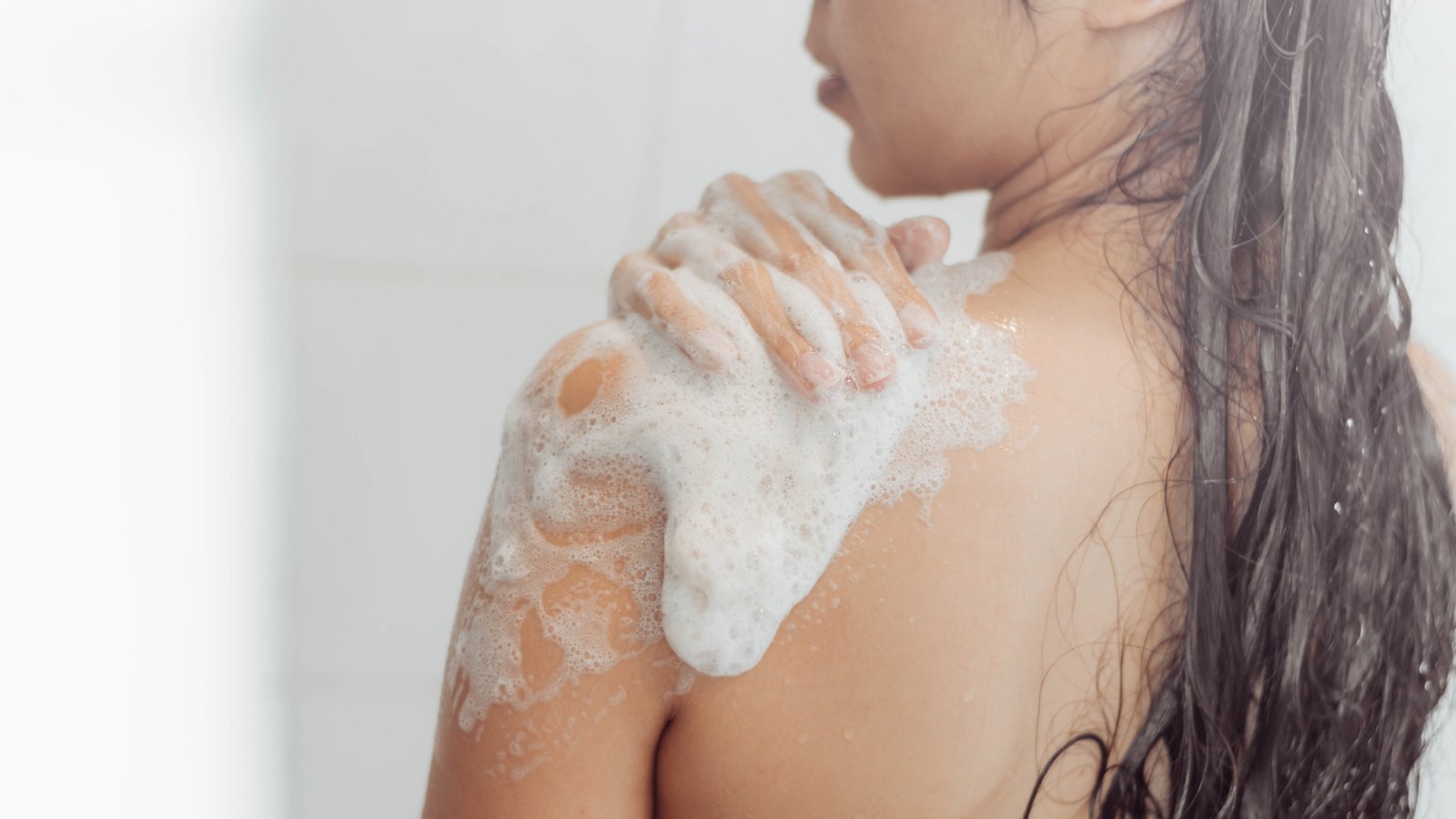 Woman-Washing-Body-In-Shower-Stock-Photo