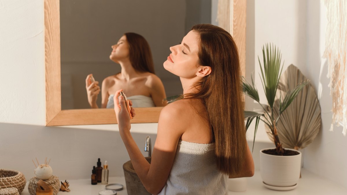 Woman-Spraying-Perfume-Stock-Photo
