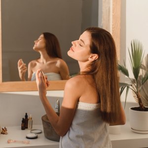 Woman-Spraying-Perfume-Stock-Photo