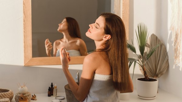 Woman-Spraying-Perfume-Stock-Photo