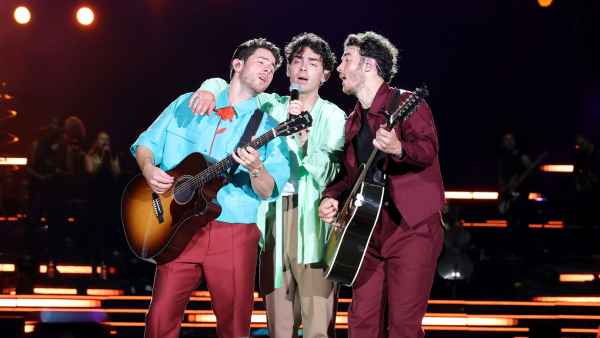 Joe Jonas Hugs Brothers Kevin and Nick During The Tour