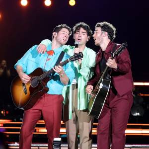 Joe Jonas Hugs Brothers Kevin and Nick During The Tour