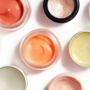 Creamy make up products - top view of decorative cosmetic containers isolated on white backgroiunds